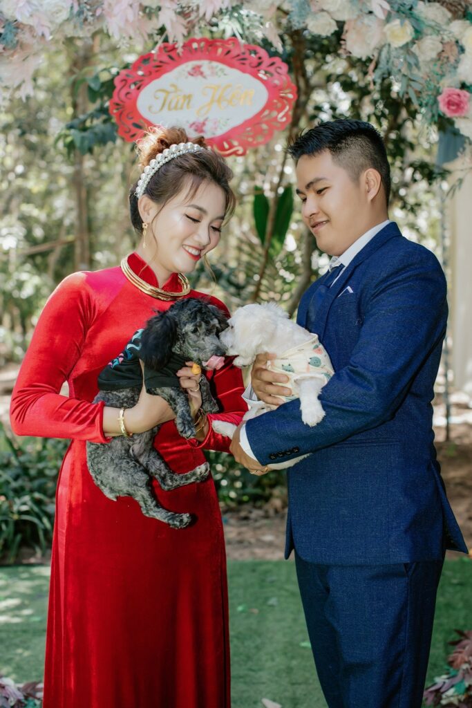 2 dogs, bride, and groom