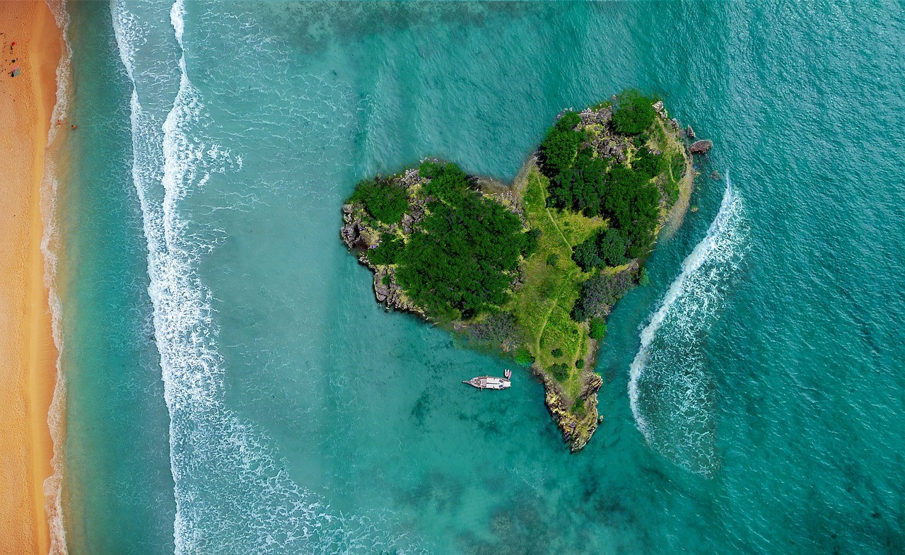 A green, forested island in the shape of a heart