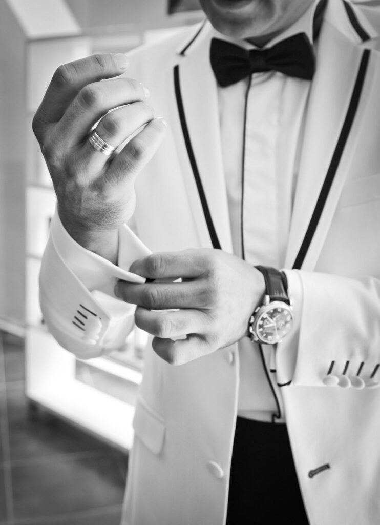 groom in white tuxedo