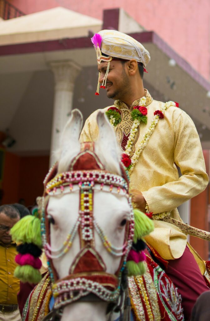 Indian groom rides decorated horst to wedding