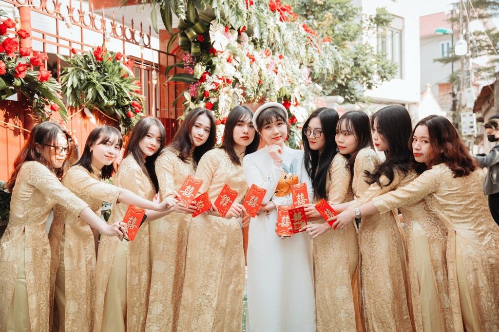 ASian bride in white and bridesmaids in beige
