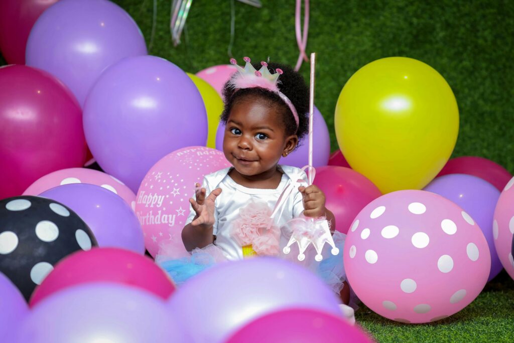 little girl surrounded by balloons