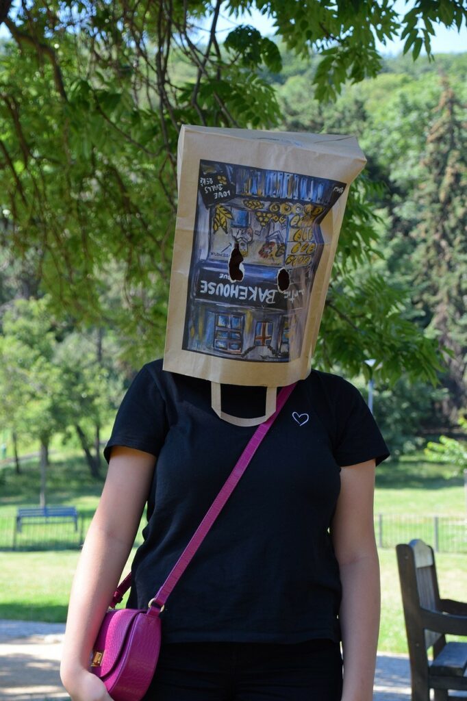 a person with a grocery bag over the head