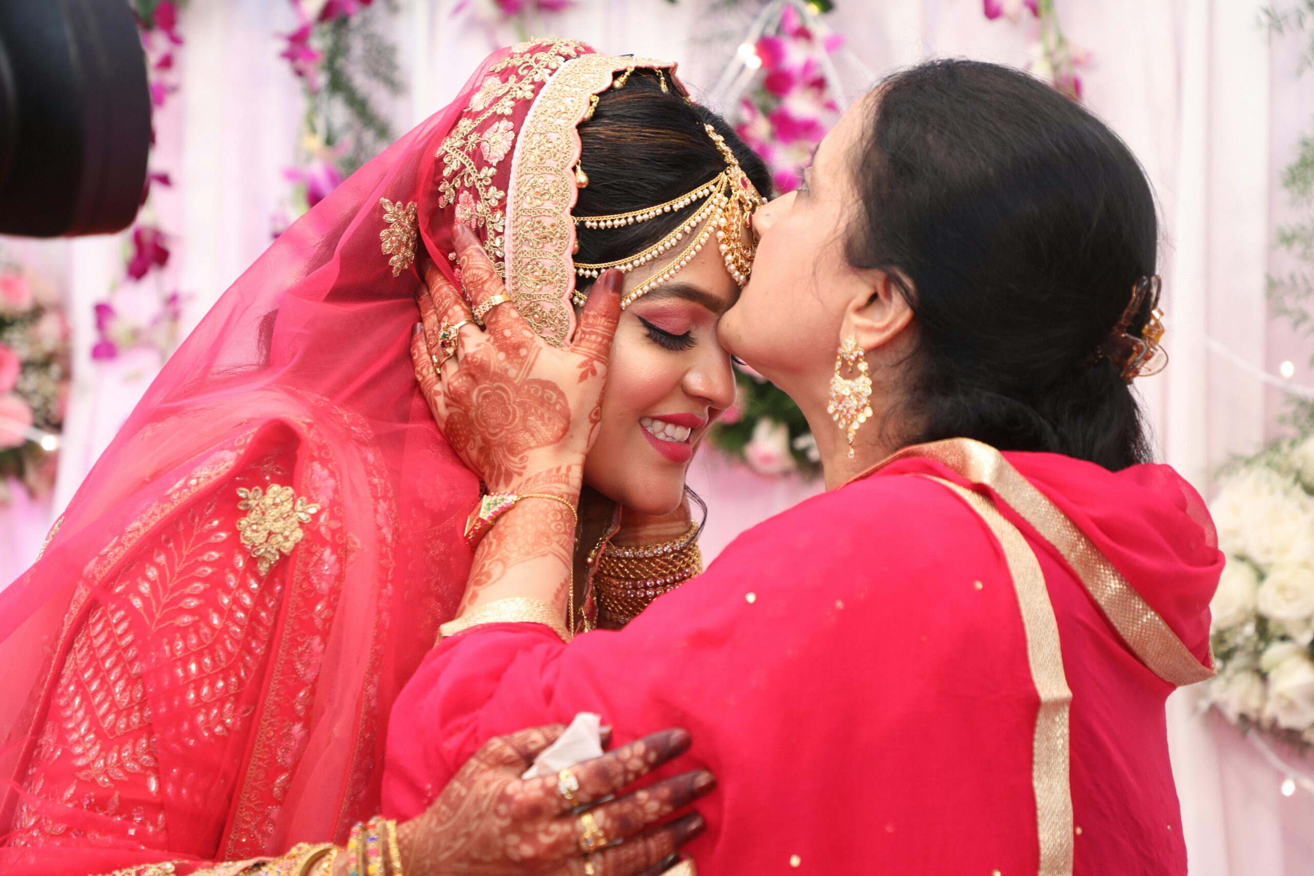 Mother kisses bride on her forehead