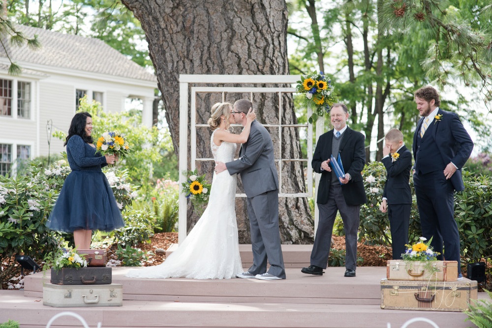 Wedding at Ainsworth House & Gardens at which officieant stands to the side.