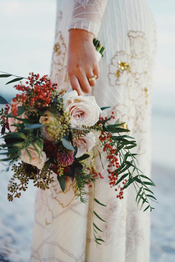 bride hold her bouquet at her side Pexels.com