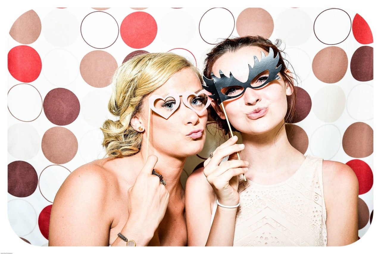 two young women with party masks Pixabay