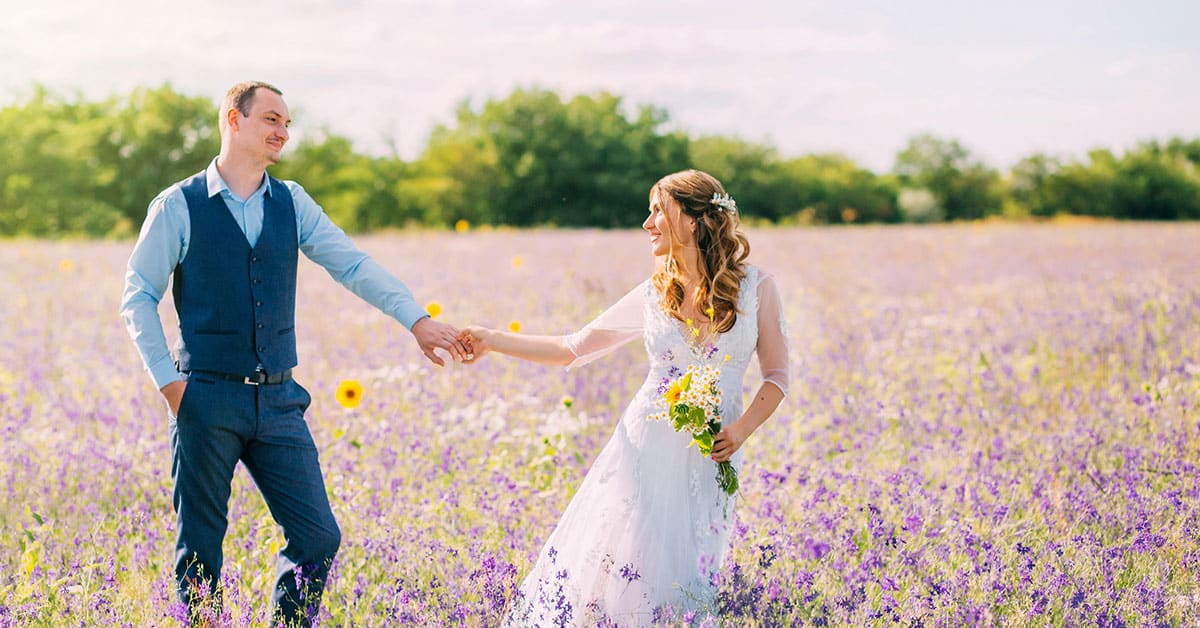 newly weds in field of flowers